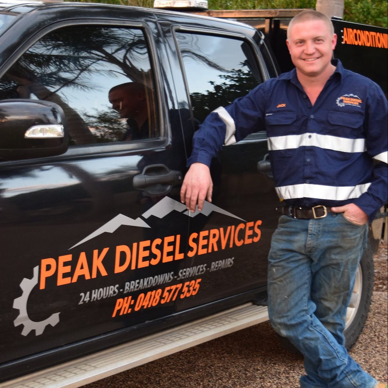 Man Standing Infront of Ute with logo design